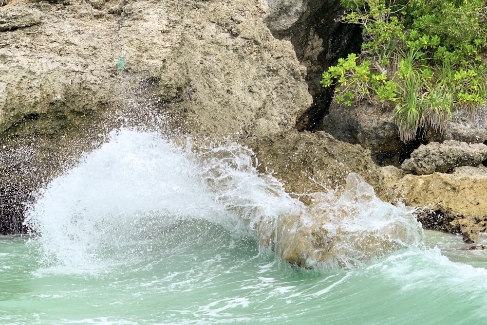 water waves hitting brown rock