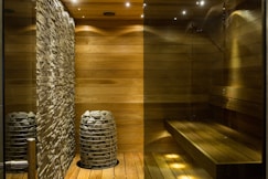 brown wooden round table near gray concrete wall