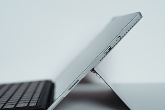 black laptop computer on white table