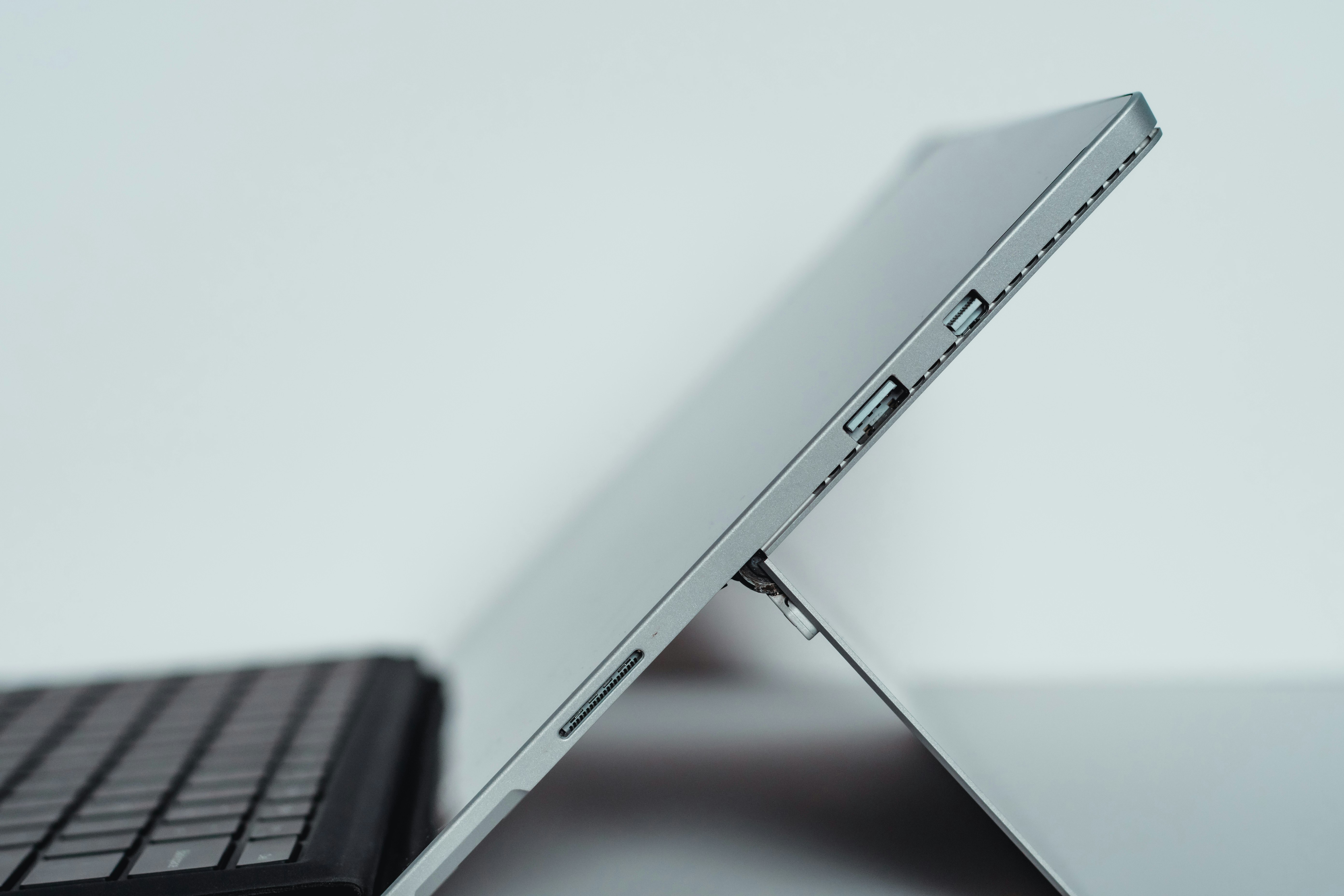 black laptop computer on white table