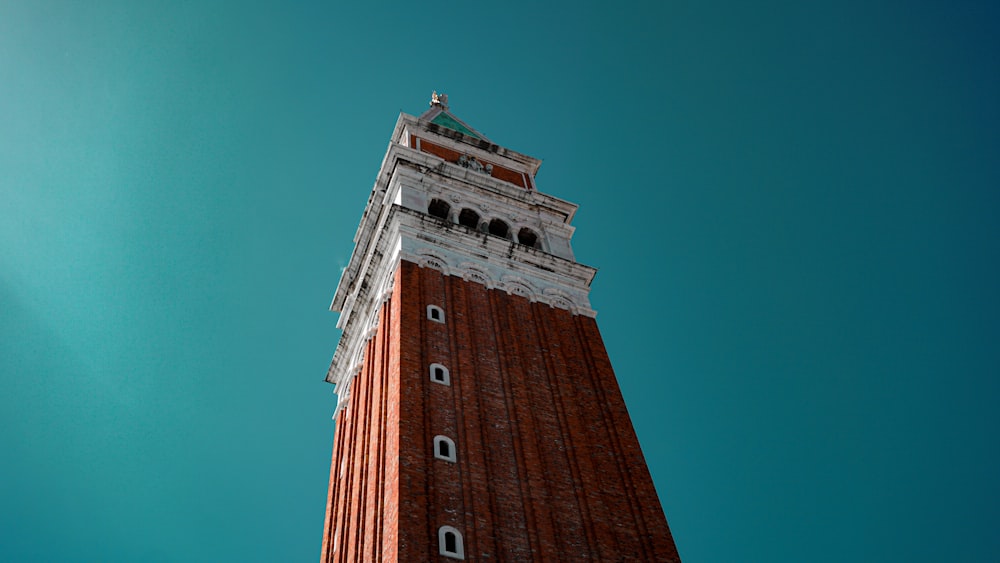 brown brick tower under blue sky