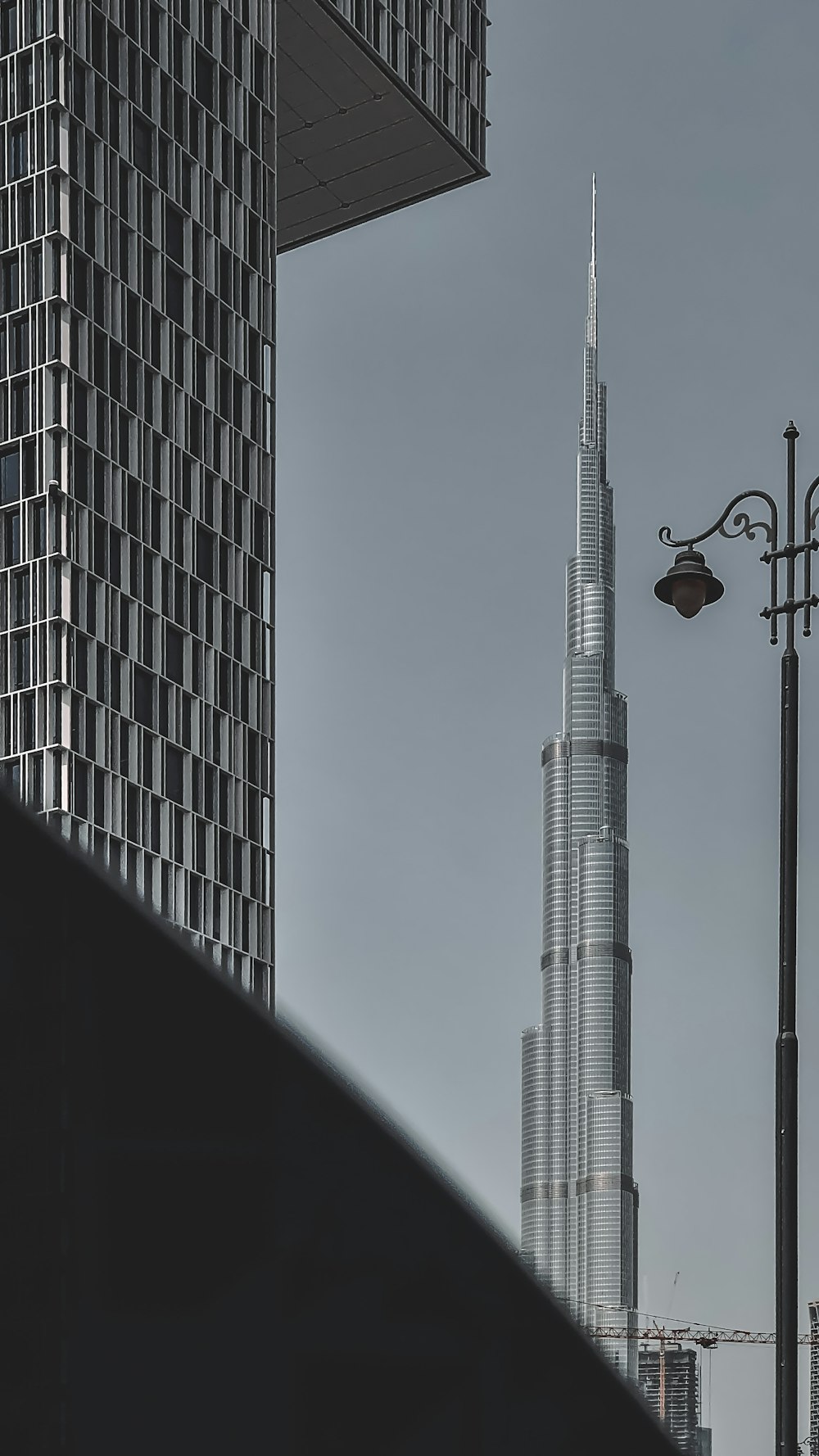 black street light near white concrete building during daytime