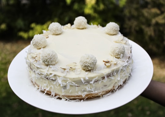 white cake with white icing on white ceramic plate