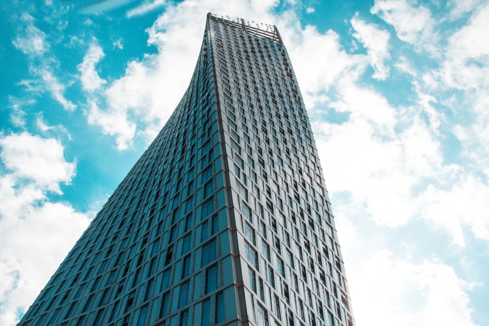 low angle photography of gray concrete building under blue sky during daytime