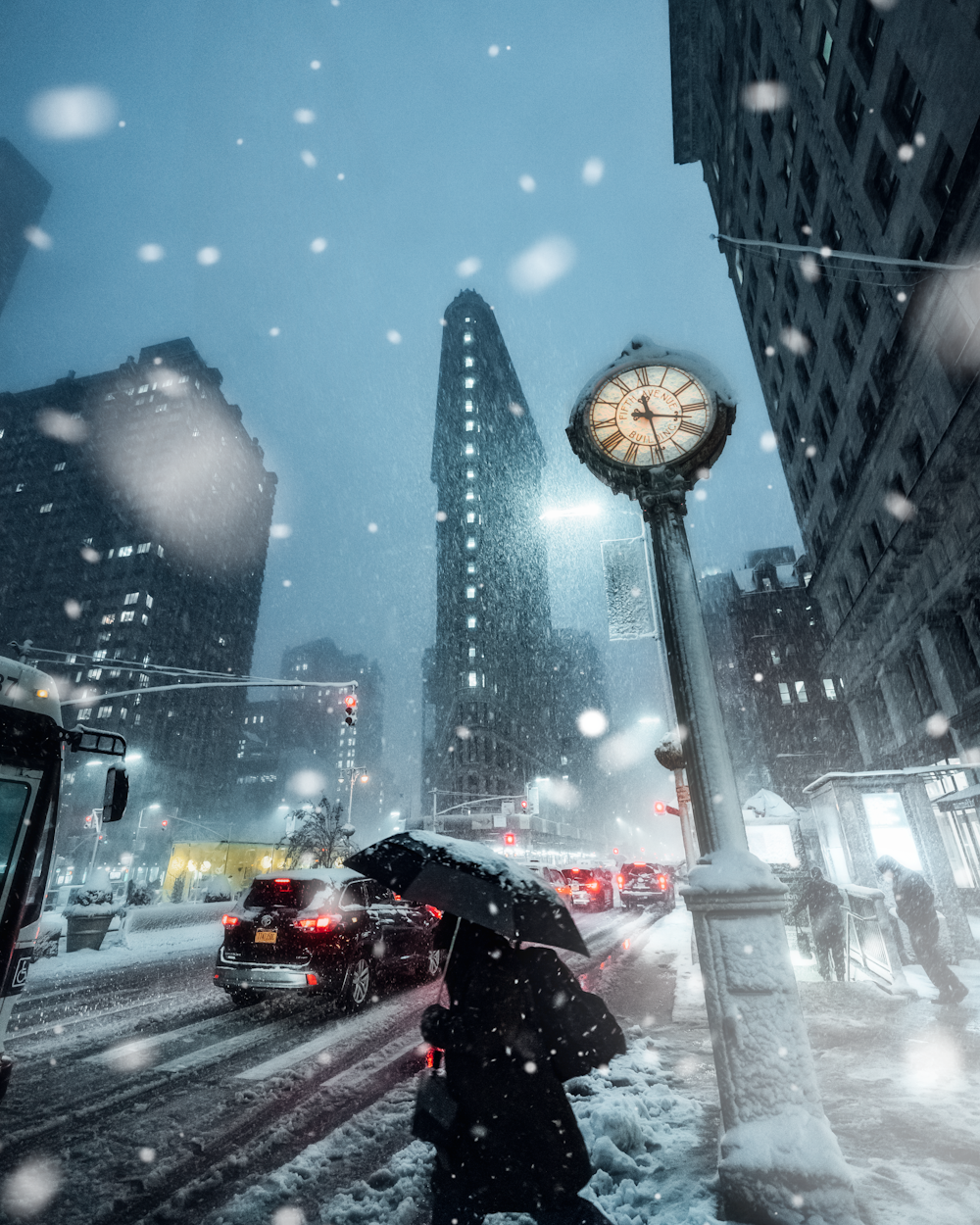 cars on road near high rise buildings during night time