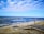 brown wooden dock on seashore during daytime
