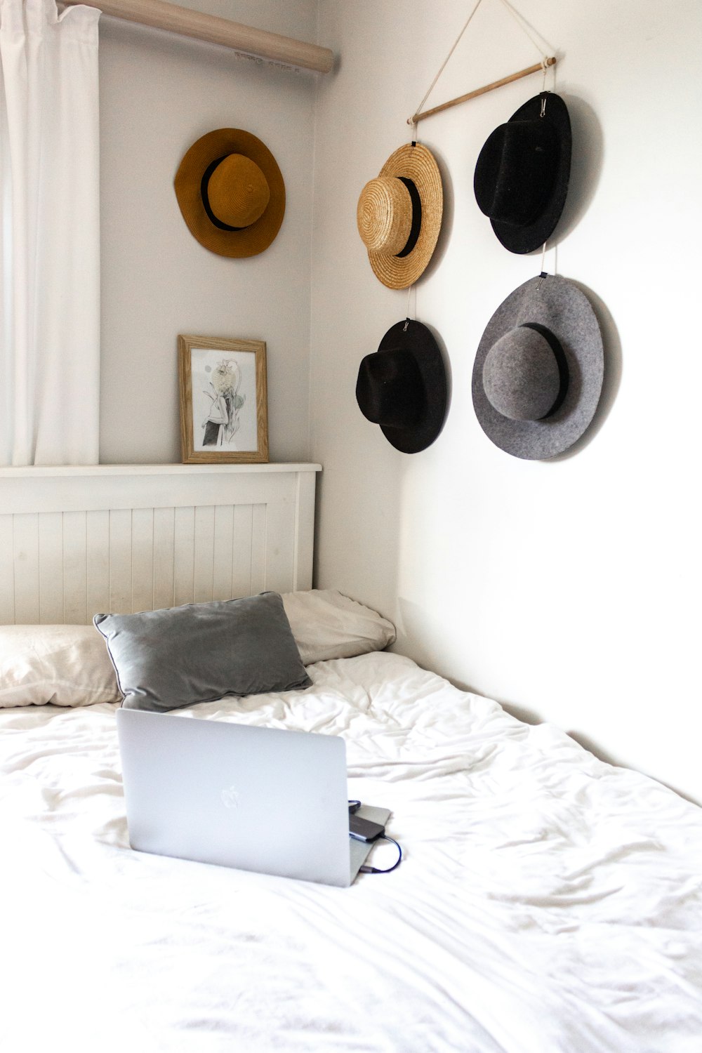 silver macbook on white bed