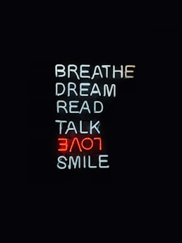 Neon signs display words vertically on a black background. The words include 'BREATHE', 'DREAM', 'READ', 'TALK', and 'SMILE' in white, with 'LOVE' in red. The overall presentation is minimalistic and artistic.