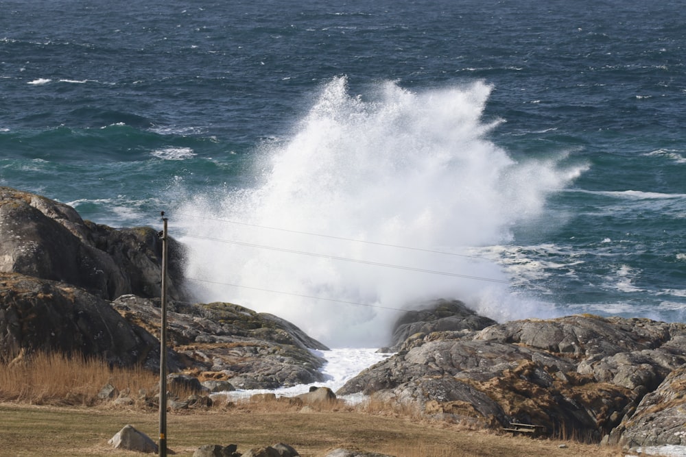 ocean waves crashing on brown rock