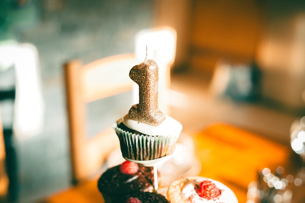 white and black cupcake with strawberry on top