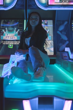 Beta testers engaging with the Proyecto Hermes game on tablets, surrounded by glowing blue and orange neon lights.