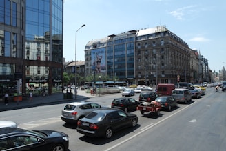 A busy city street with a variety of transport vehicles including trucks and vans.
