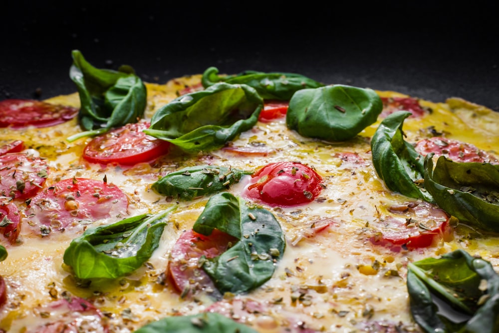 green and red pizza with green leaves