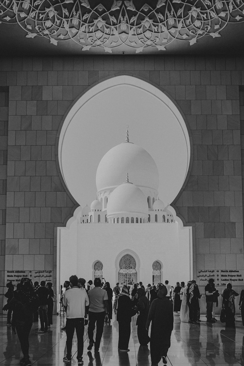 people standing in front of white dome building