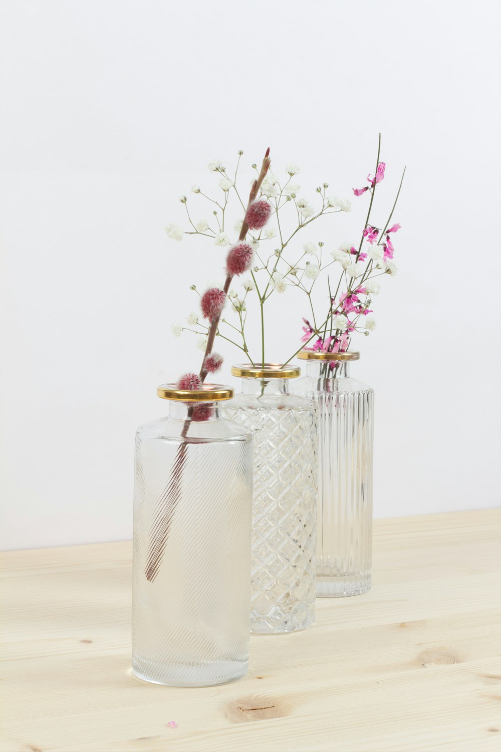 red flowers in clear glass vase