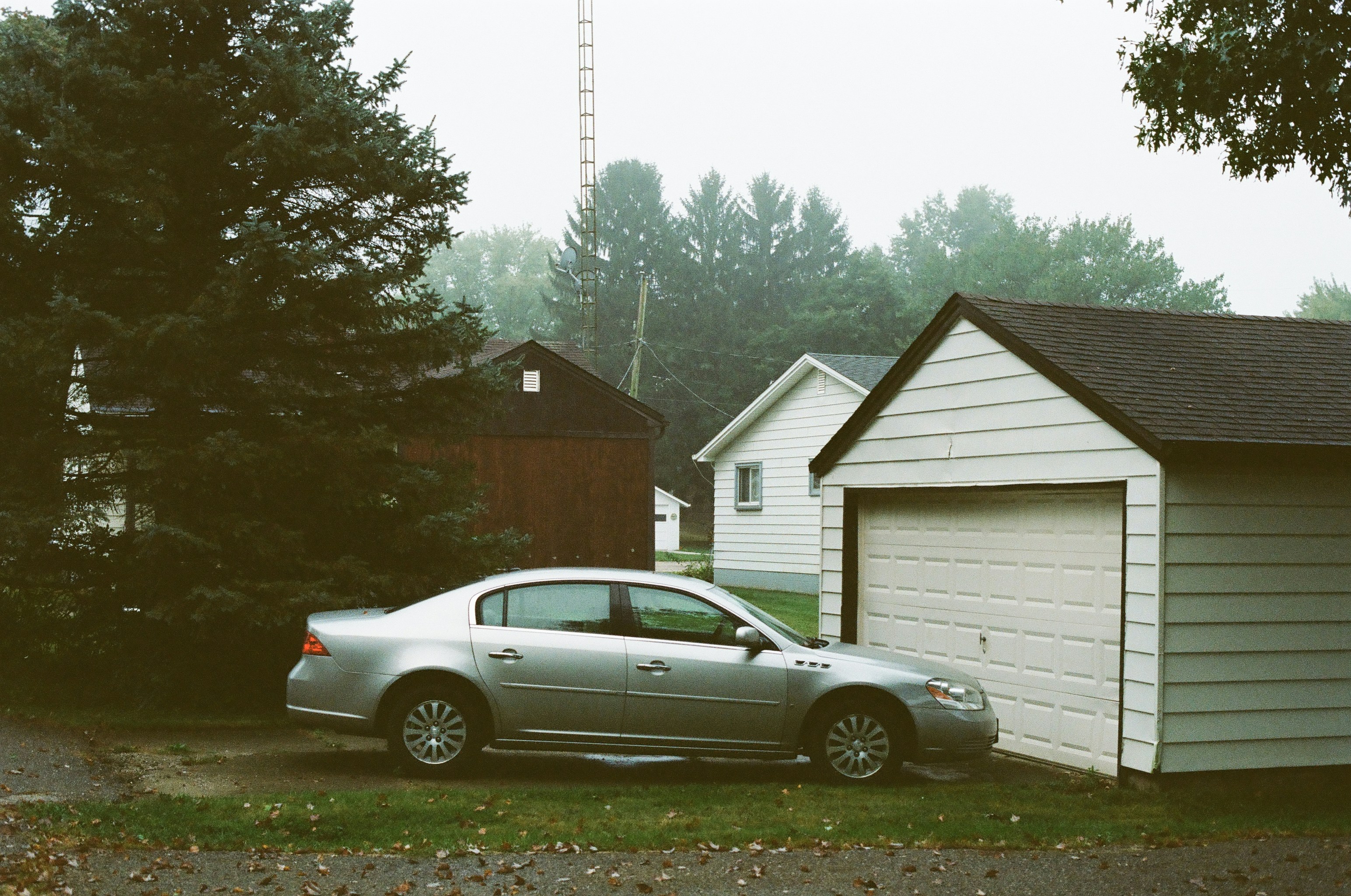 Family loading luggage into a compact electric SUV parked in a driveway
