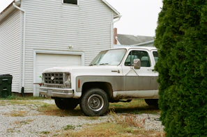 A clean driveway after a full junk removal, with a blue and green Verdelimpio truck parked nearby