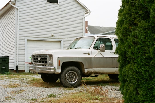 A family-owned dumpster rental truck parked in a driveway.
