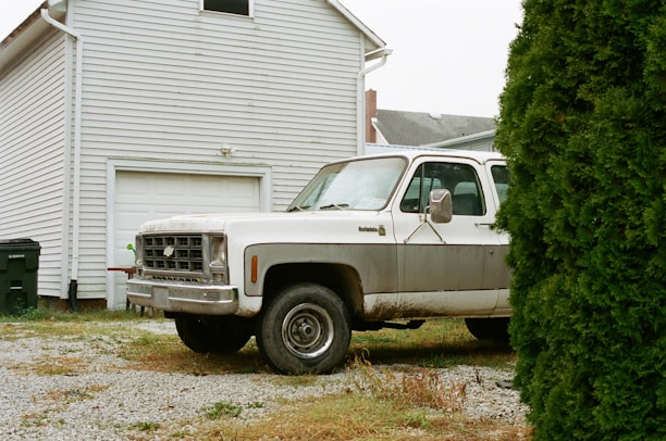 Photo of a Henry Dumpster truck parked in front of a residential property on Shady Ln.