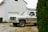 Image of a Gunk & Junk Hauling truck parked outside a tidy Austin home.