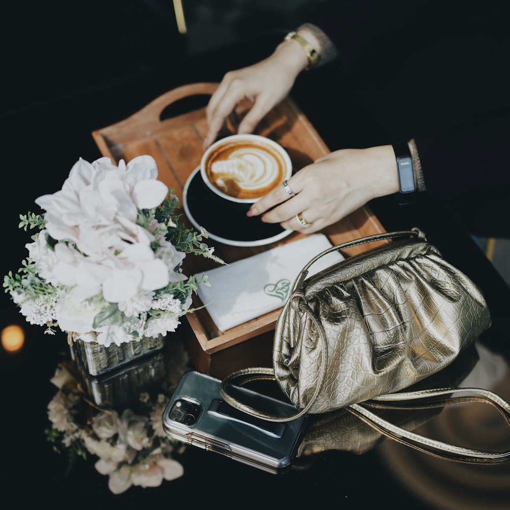 person holding white ceramic mug with coffee