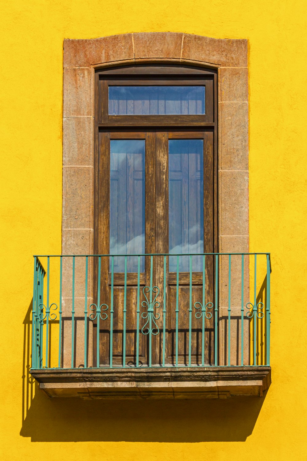 blue wooden door on yellow concrete building