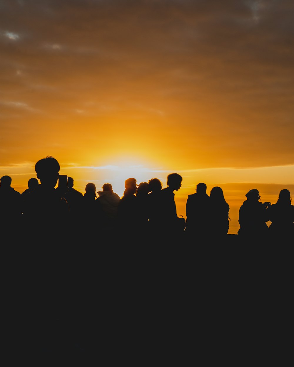 silhouette of people standing during sunset