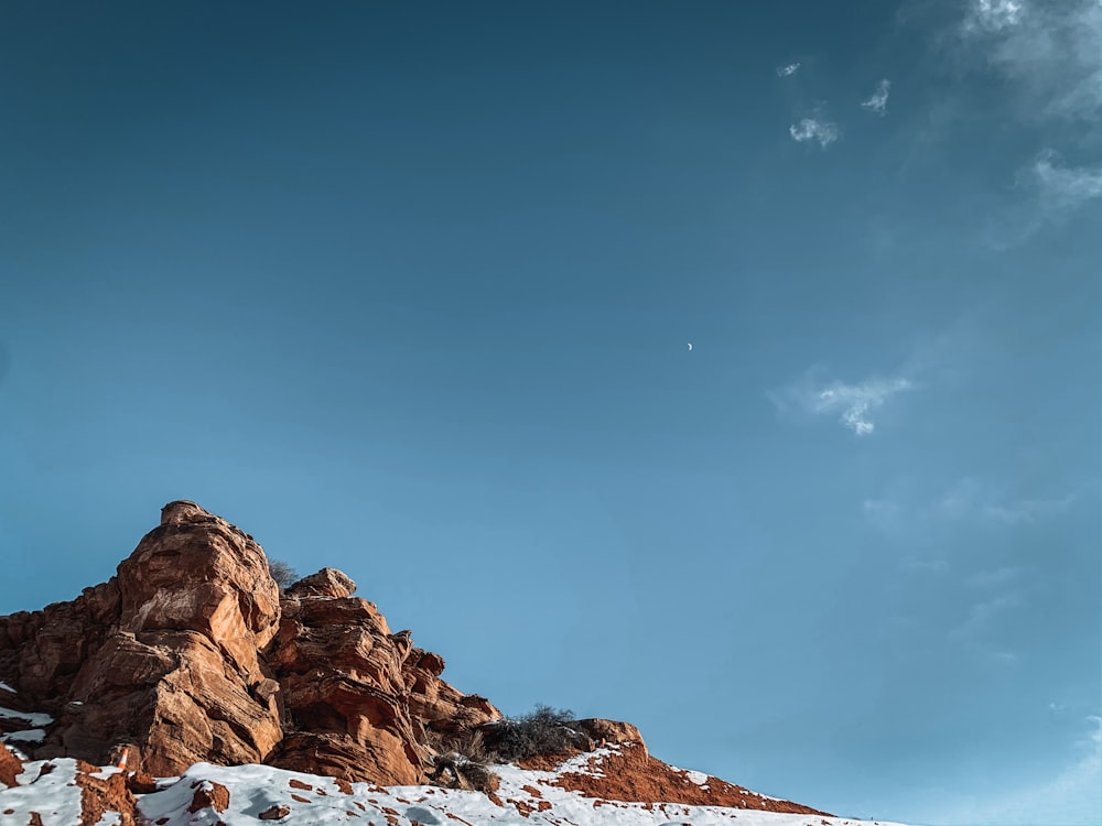 brown rocky mountain under blue sky during daytime