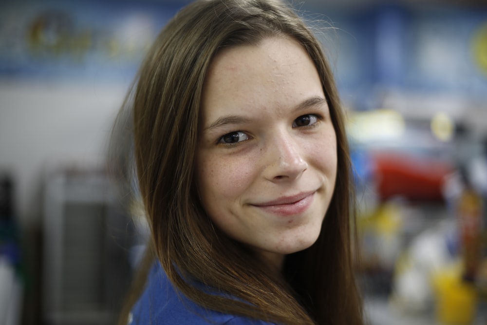 woman in blue crew neck shirt smiling