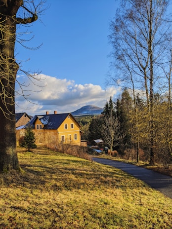 A welcoming countryside home near Collorec, framed by lush greenery under a bright sky.