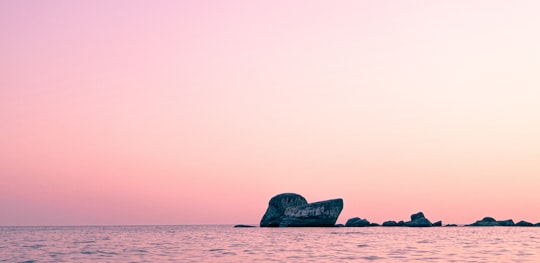 black rock formation on sea during daytime in South Goa India