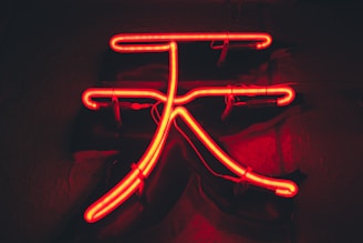 Close-up of a glowing neon green energy symbol representing consciousness