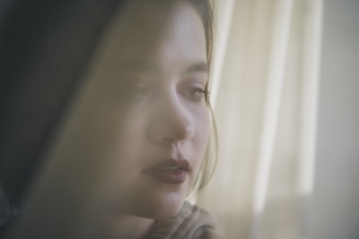 Soft focus portrait of a smiling woman with a warm, inviting gaze.