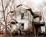 An eerie abandoned house with broken windows.