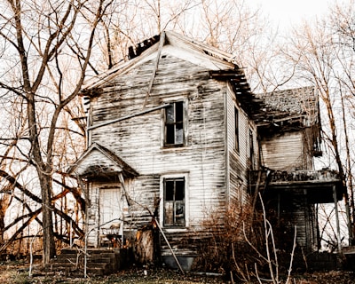 An eerie abandoned house with broken windows.