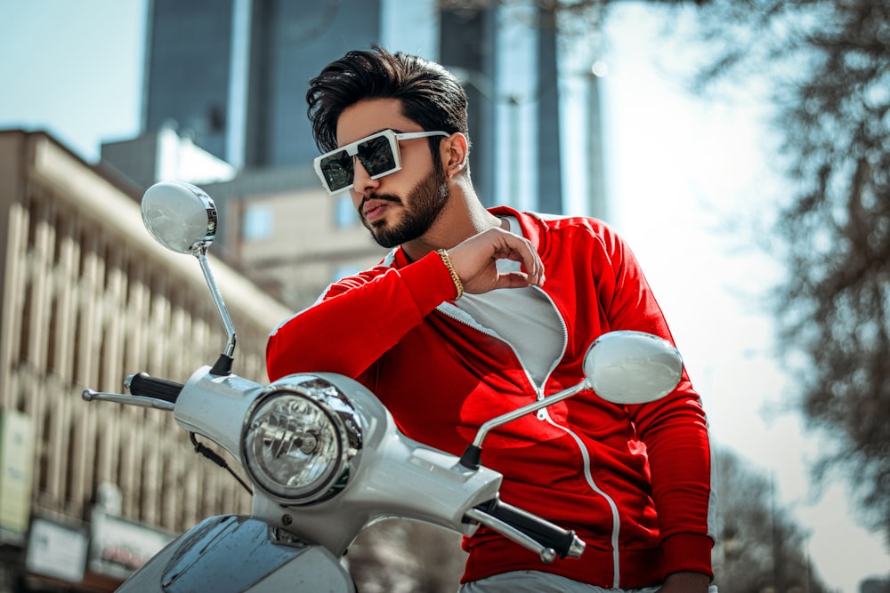 man in red long sleeve shirt riding motorcycle