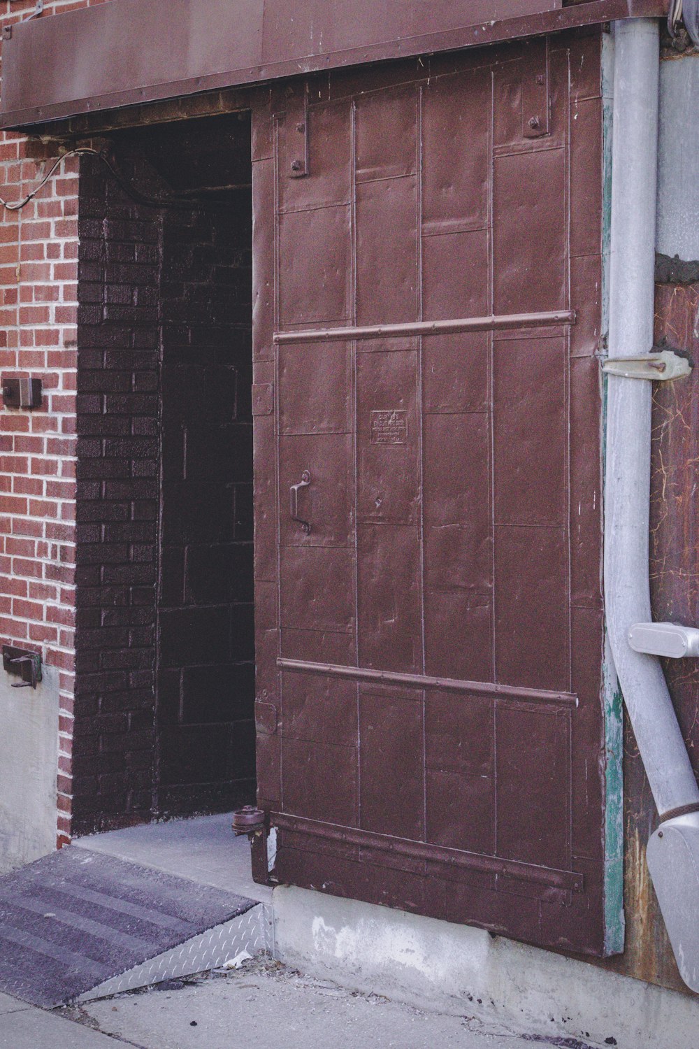 brown brick wall with brown wooden door