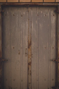 Close-up of a door with visible surface imperfections and misaligned edges.