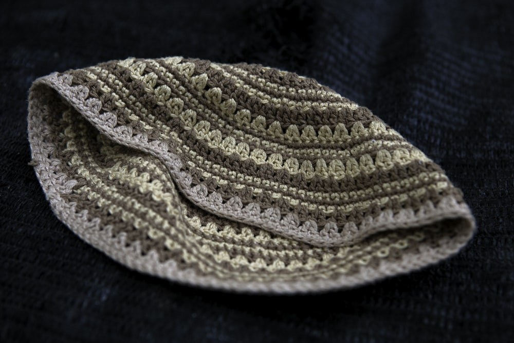 white knit cap on blue textile