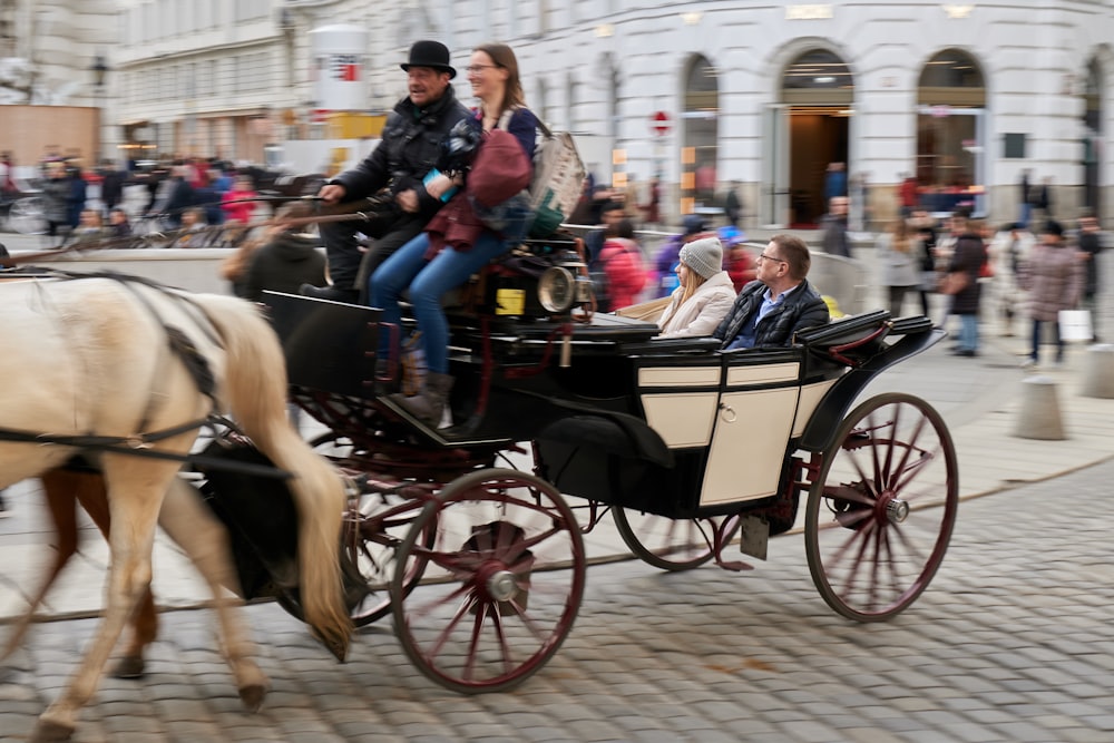 people riding on black horse during daytime