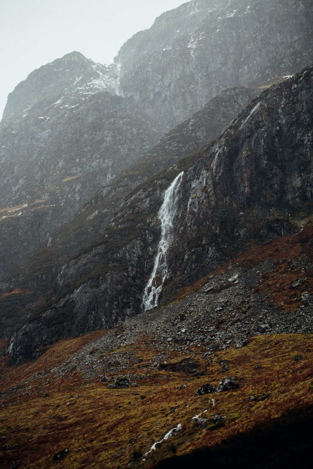 waterfalls on rocky mountain during daytime