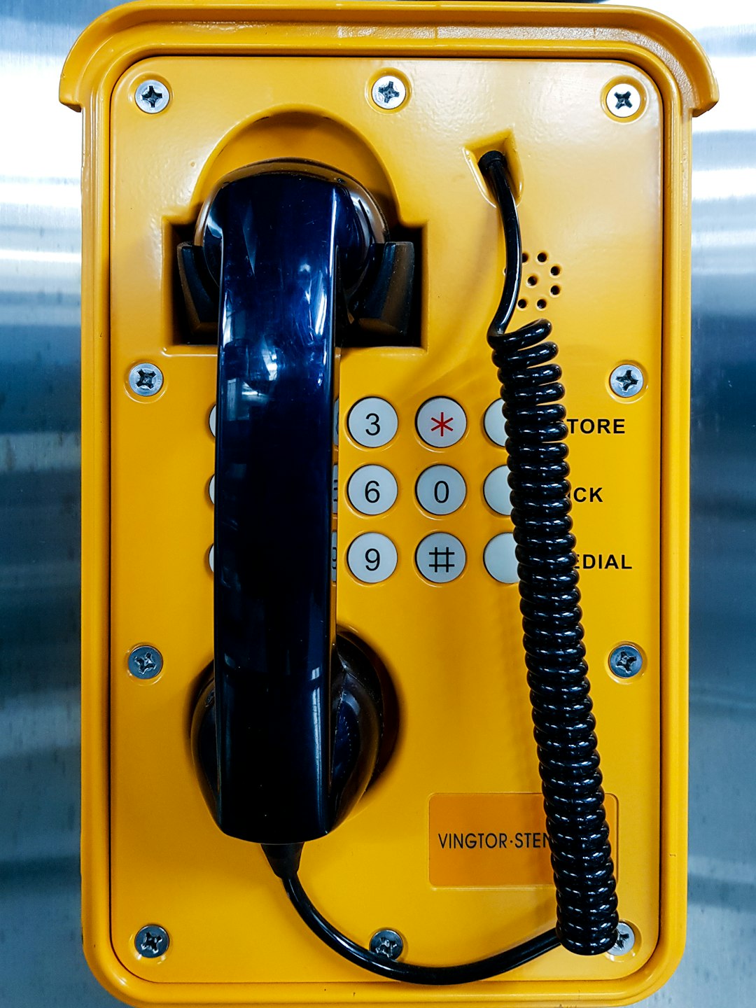 yellow and black telephone on white wall