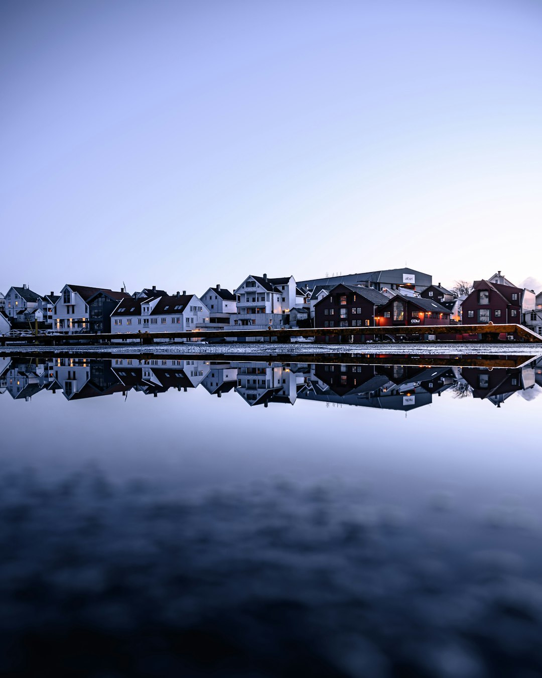 brown and white building near body of water during daytime