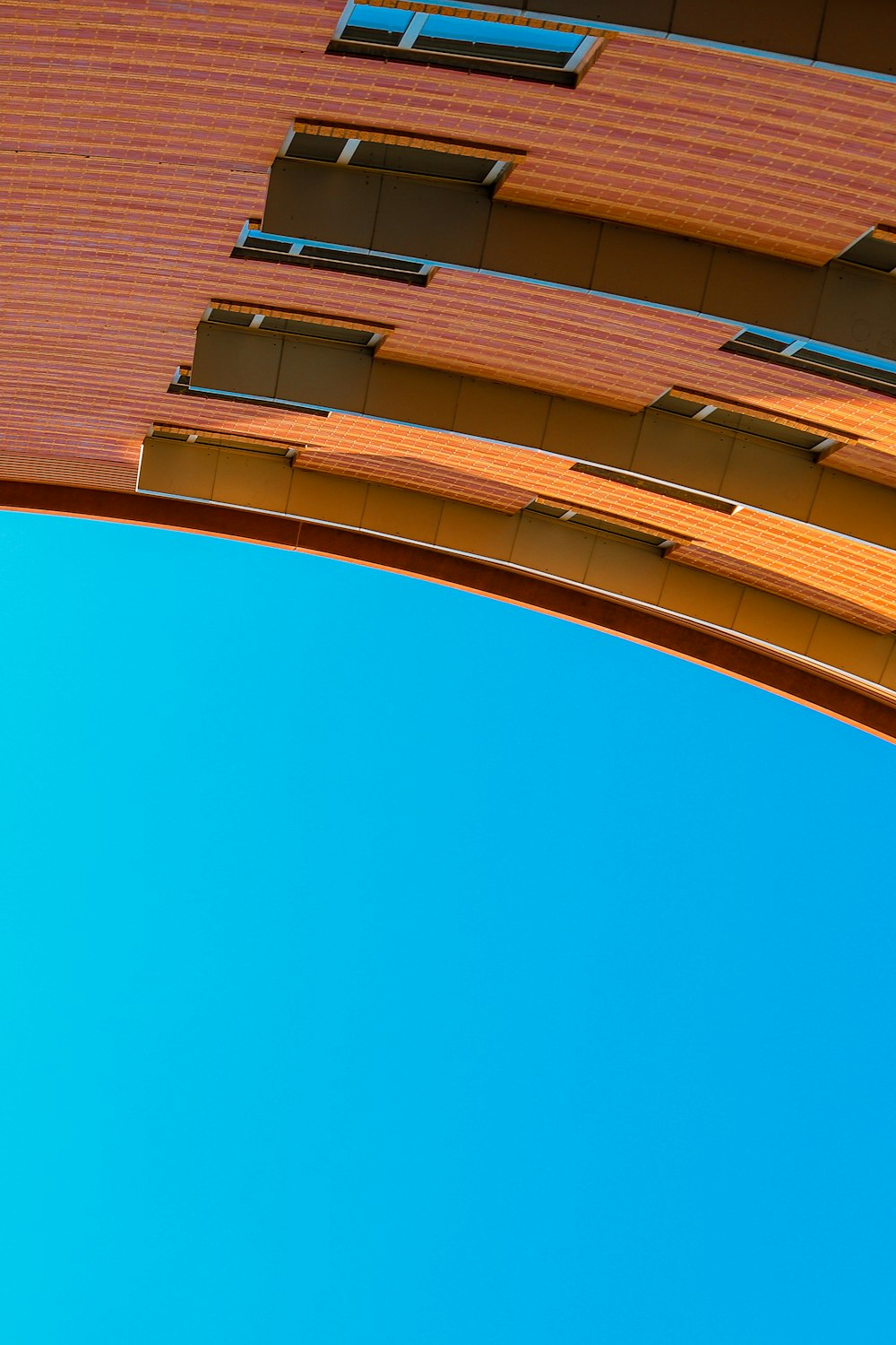 brown concrete building under blue sky during daytime