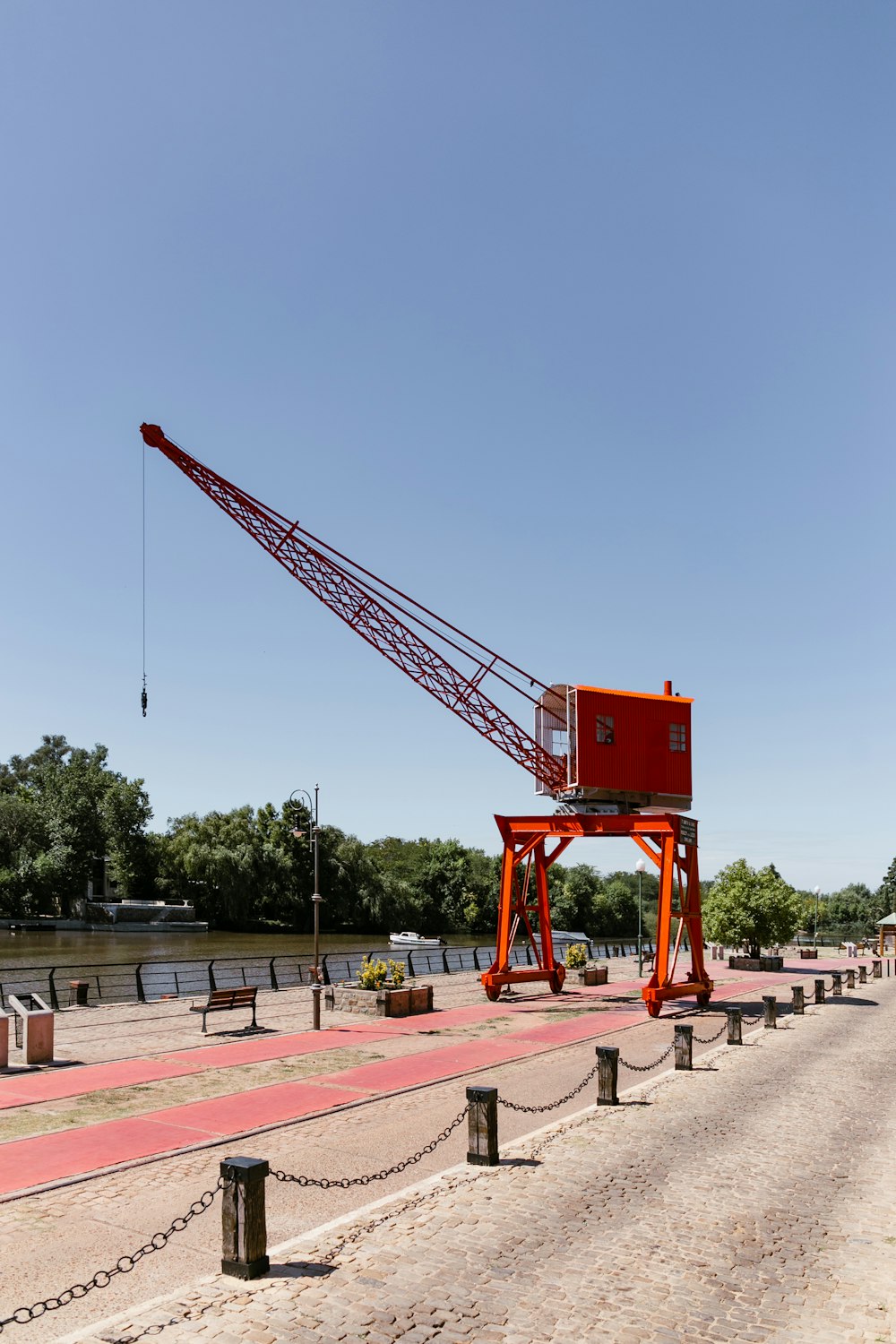 red crane on brown concrete floor during daytime