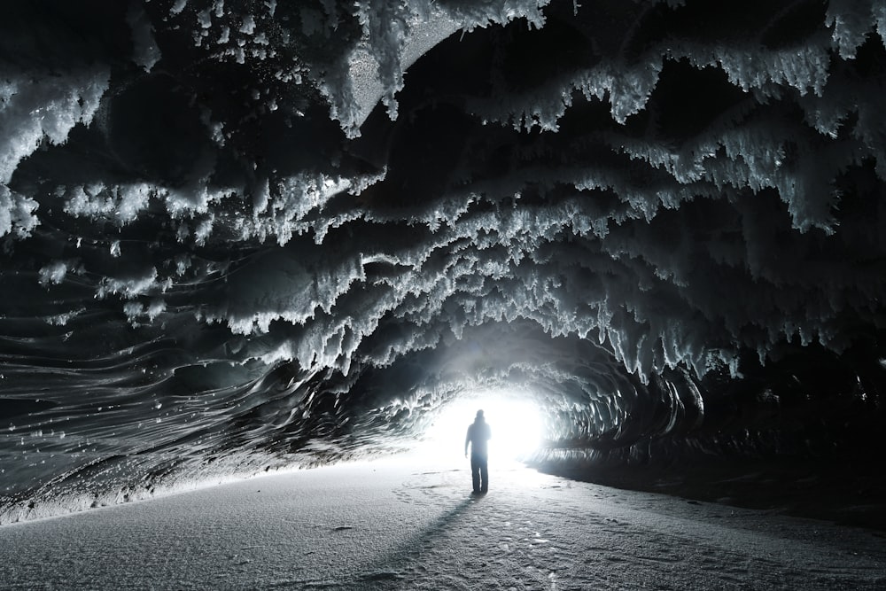 person walking on snow covered field during daytime