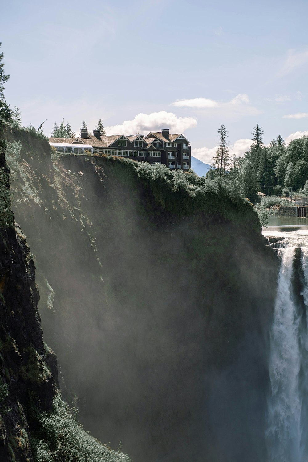 brown wooden bridge over waterfalls