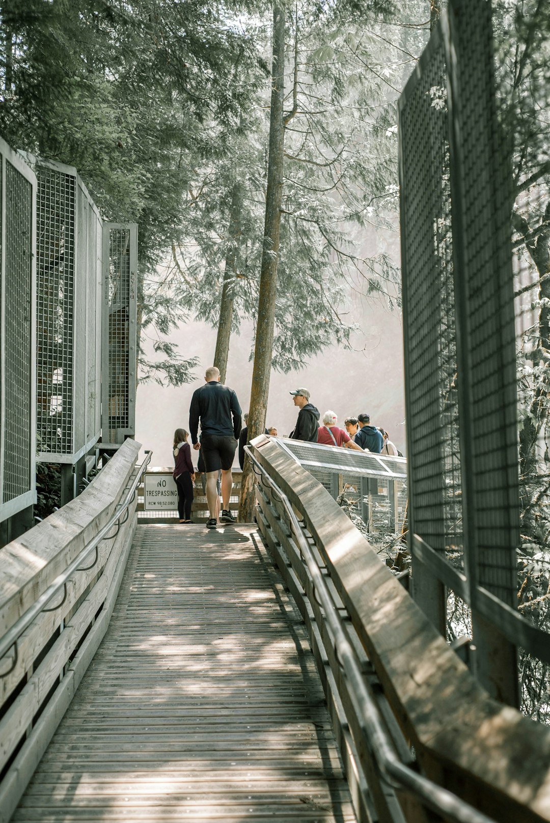 people walking on wooden bridge during daytime