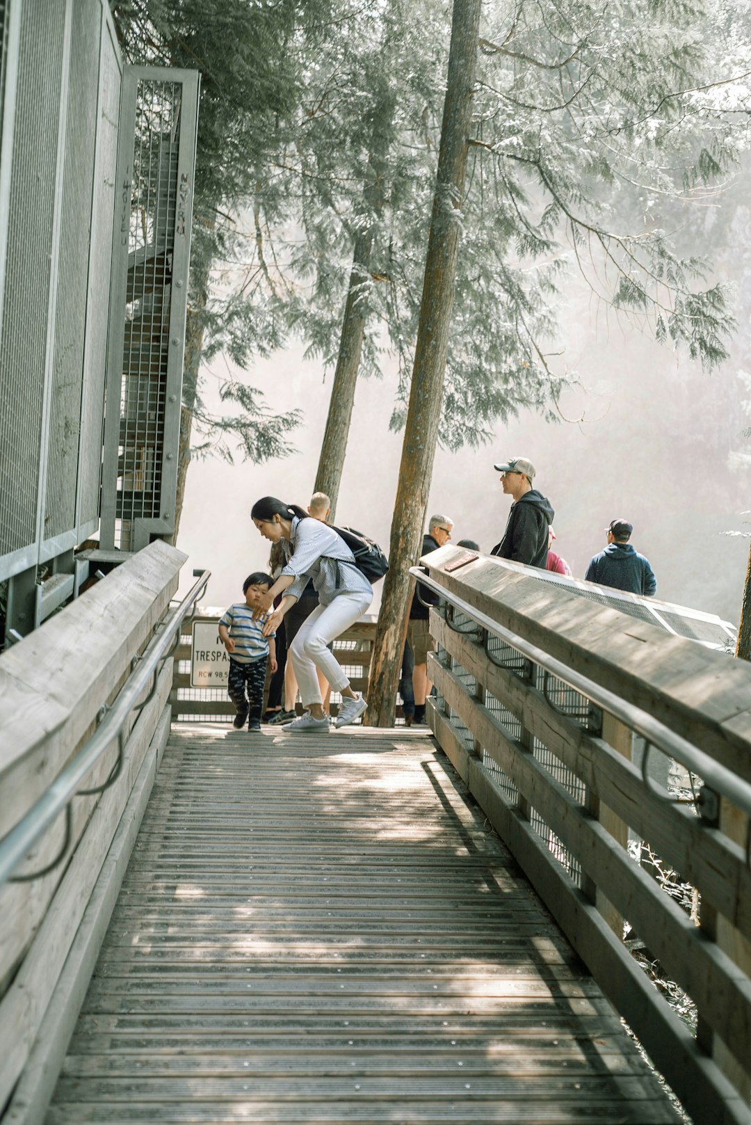 people walking on wooden bridge during daytime