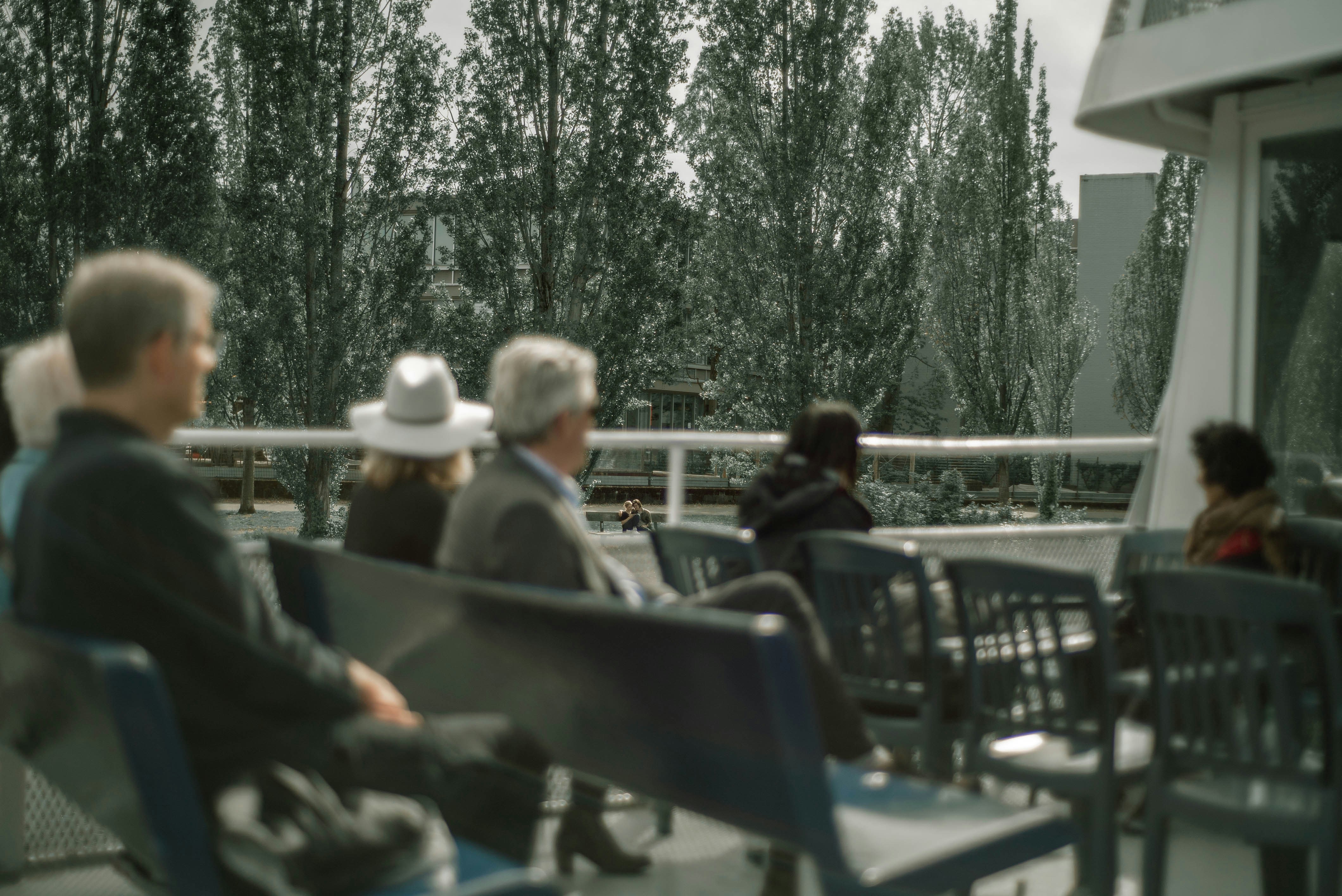people sitting on white chairs during daytime